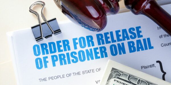 money and gavel over a prisoner release form